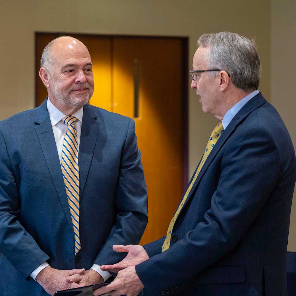 Pete Pantuso conversing with an industry colleague